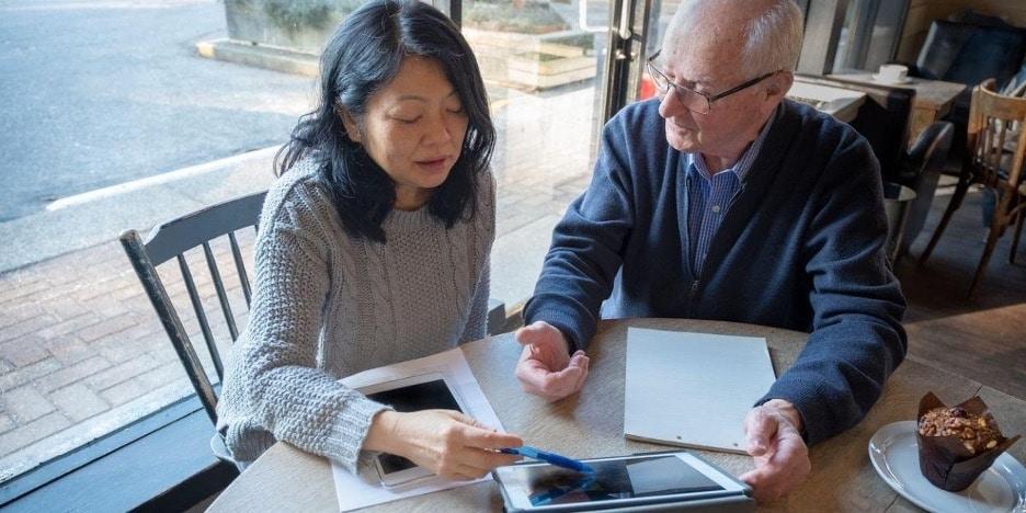 Couple sitting at desk planning out portfolio 